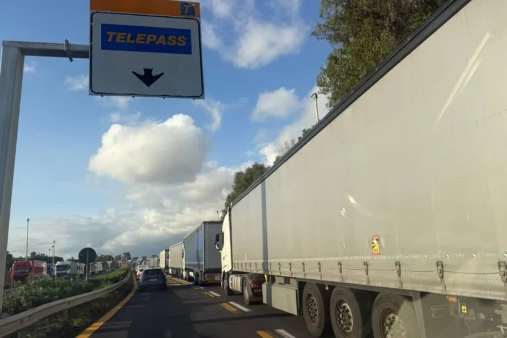 Forze dell'ordine scortano mezzi di trasporto durante un'operazione contro i blocchi stradali.